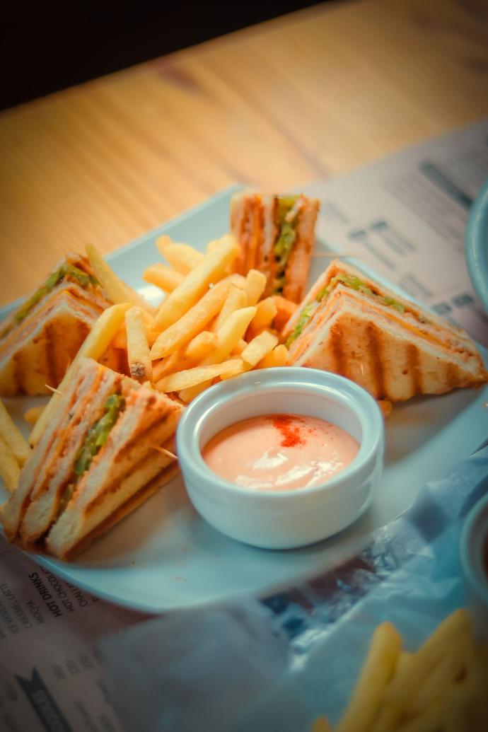 fries on white ceramic bowl beside white ceramic bowl with sauce